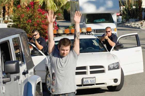 Police Officer Arresting Young Man
